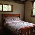 Queen size bed in Rammed Earth Studio